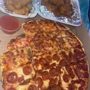 a pepperoni pizza and chicken wings
