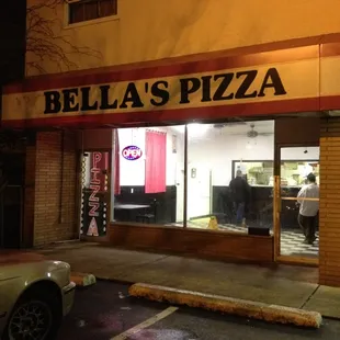 a car parked in front of a restaurant