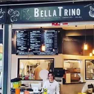 a woman standing in front of a restaurant