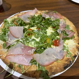 GLUTEN FREE CRUST! FRESH Mozzarella, Roasted Grape Tomatoes, Arugula and Prosciutto with Fresh Basil and Extra Virgin Olive Oil. Delish!