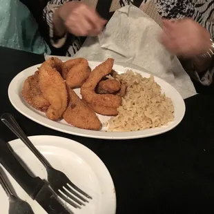 a plate of fried fish and rice