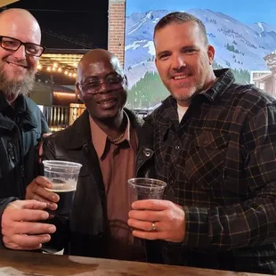 two men holding beer glasses