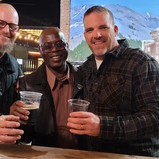 two men holding beer glasses