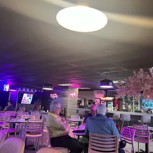 people sitting at tables in a restaurant