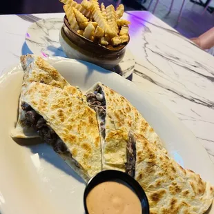 a quesadilla and fries