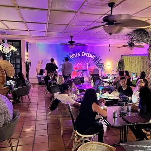people sitting at tables in a restaurant