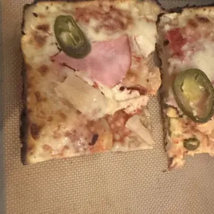 Ham, pineapple, and jalapeños. Not a lot of toppings, the sauce is all pooled in the middle because the pizza didn&apos;t rise properly.