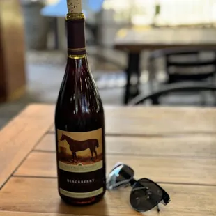 a bottle of wine and sunglasses