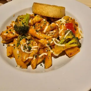 a plate of pasta with broccoli and cheese