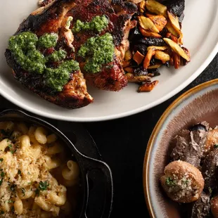 a plate of meat, macaroni and cheese, and a bowl of macaroni and cheese