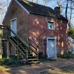 a brick building with stairs leading up to it