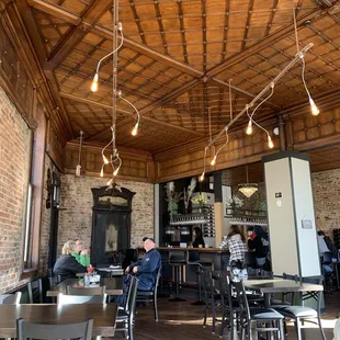 dining area with exposed wood ceiling