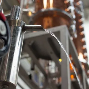 a close up view of a copper distilling machine