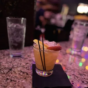 a glass of cocktail on a table
