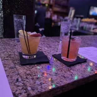two cocktails on a bar counter