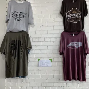 t - shirts hanging on a brick wall