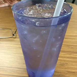 a purple drink with a straw