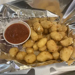 a plate of fried potatoes and sauce