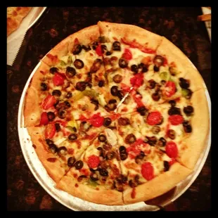 a pizza with olives and peppers