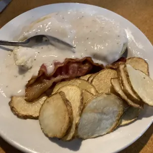 Fried potatoes, bacon, gravy over biscuits.