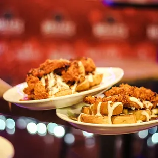 two plates of fried chicken sandwiches