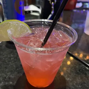 a pink drink with a lime wedge