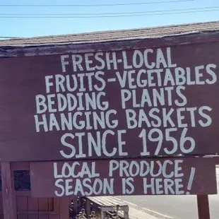 a sign for fresh local fruits and vegetables