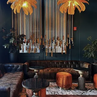a living room with leather furniture and a chandelier