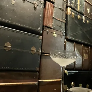 Drink and wall of suitcases