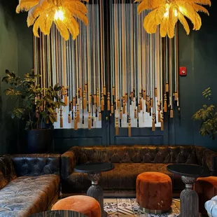 a living room with couches, chairs, and chandeliers