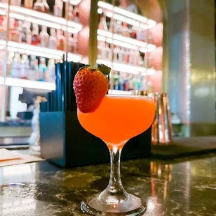 a drink with a strawberry on the rim