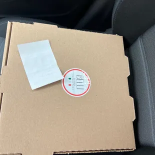 a pizza box in the back of a car