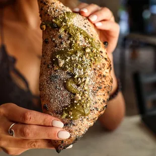 a woman holding a piece of food