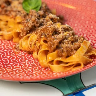 a plate of pasta with meat and cheese