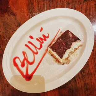 Tiramisu -- Three layers of lady fingers soaked in coffee and liqueur, filled with zabaglione cream, topped with grated Belgium Chocolate