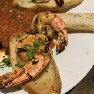 Grilled shrimp marinated in white wine, lemon juice, olive oil, and herbs