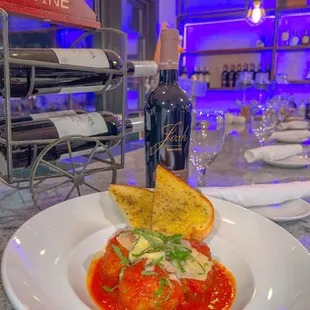 a plate of food and a bottle of wine