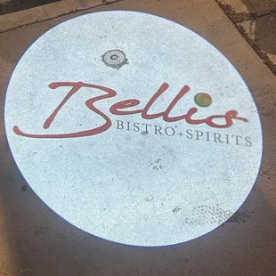 a circular sign on a sidewalk