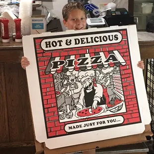 a boy holding a hot and delicious pizza