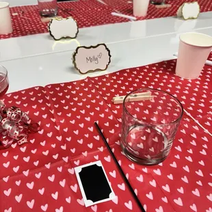 a table with a red tablecloth and a glass of wine