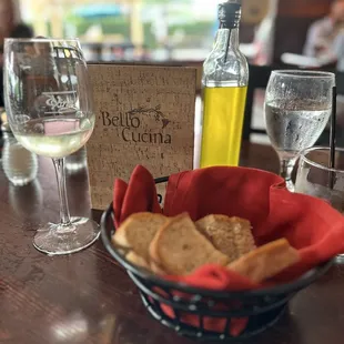 a basket of crackers and a glass of wine