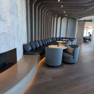 a curved seating area with a fireplace