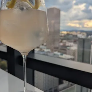 a glass of wine with a view of a city
