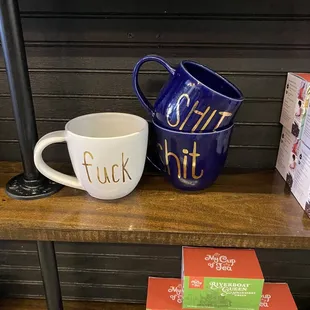 a coffee cup and a mug on a shelf
