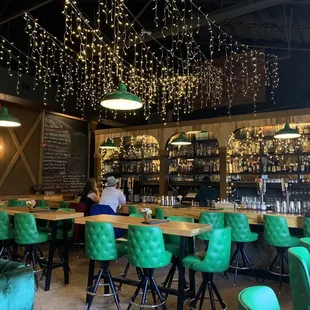 a bar with green chairs