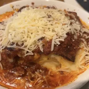 Baked lasagna, topped with extra Parmesan (they ask you to tell them to stop while adding it on)