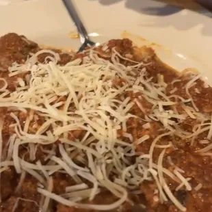 Meat sauce spaghetti with meatballs, my son had added Parmesan on top