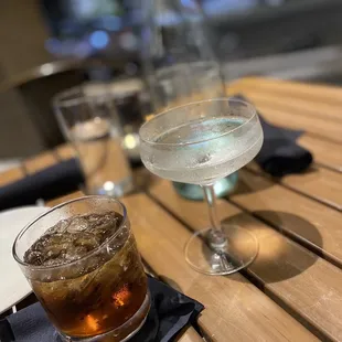 a glass of water and a drink on a table