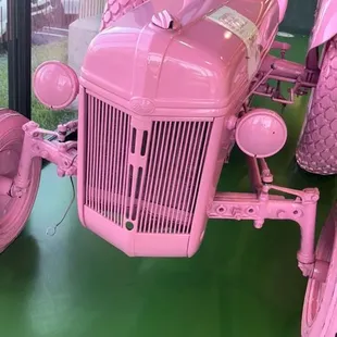 a pink tractor on display