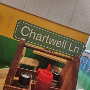 a table with condiments and a street sign